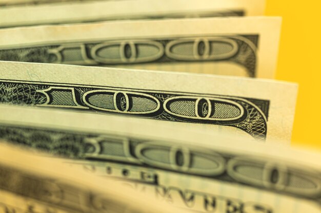 Photo close-up of bunch dollar bills with selective focus, one hundred dollar banknotes macro photo