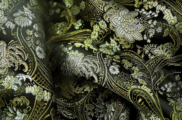 a close up of a bunch of gold and green floral designs