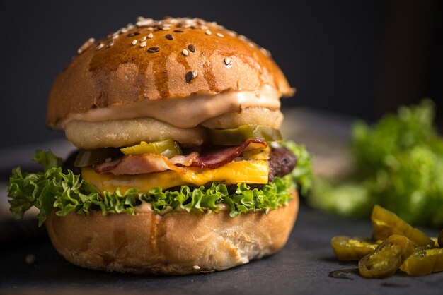 Close-up of burger against black background