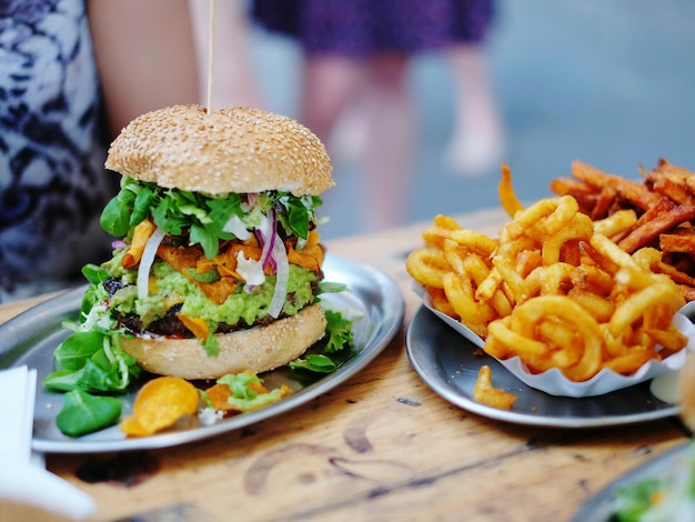 close-up of burger and french fries in plate on table