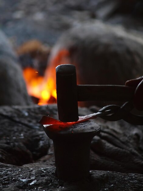 Photo close-up of burning candle on wooden log