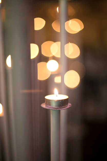 Close-up of burning candles in church