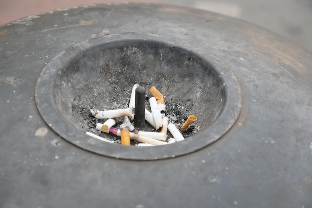 Close up burning cigarette in ashtray on table