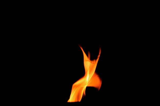 Photo close up burning flames on black background for graphic design or wallpaper