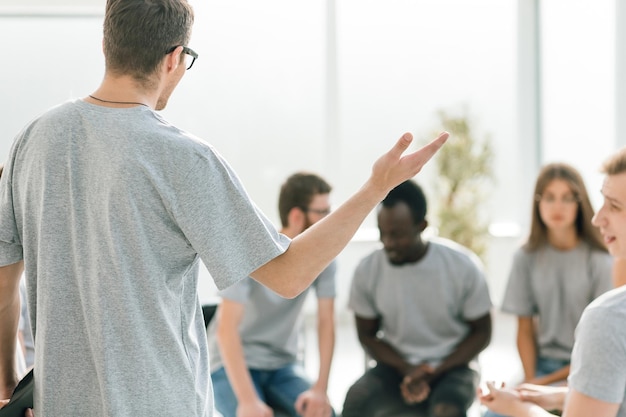 Close up. business coach holds a debate with a group of young people . business and education