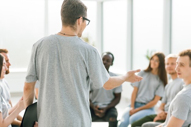 Close up. business coach holds a debate with a group of young people . business and education