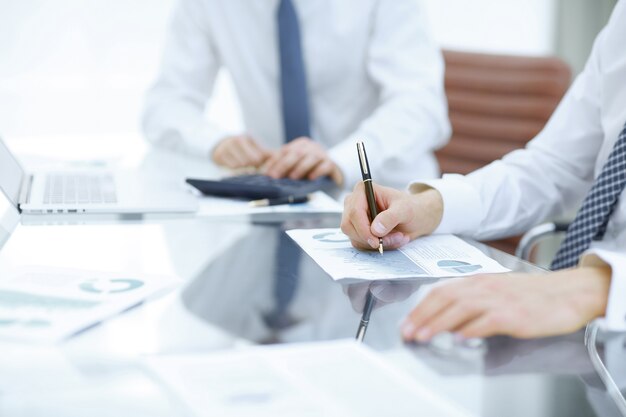 Photo close up business colleagues compiling financial report