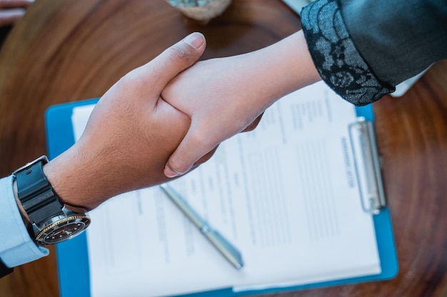 Close up of business hand shaking during meeting