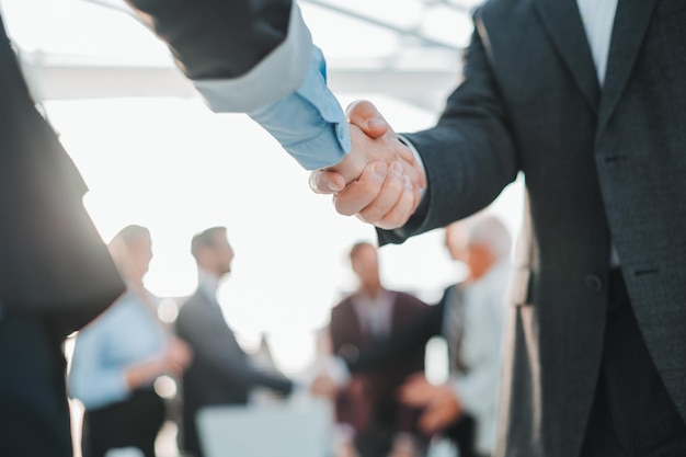 Close up business handshake on an office background