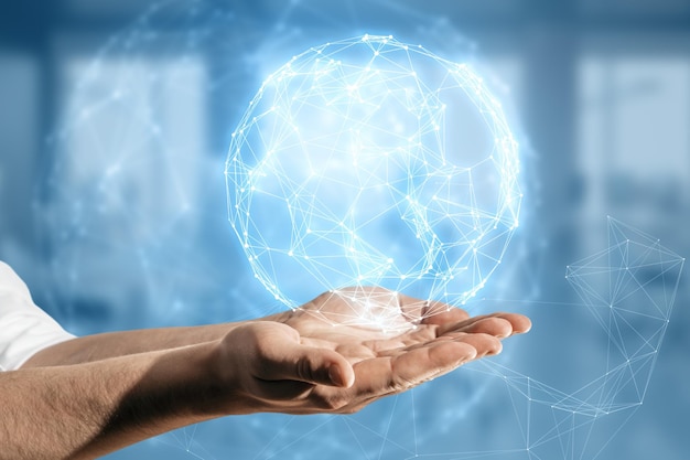 Close up of business man hand using glowing polygonal globe hologram on blurry background Connection Structure Digital Data Visualization Social Network Graphic Concept