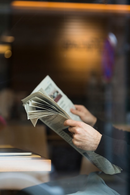 close-up business man reading newspaper