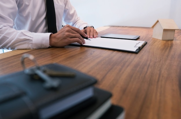 Close up of business man signing contract documents making a deal concept.