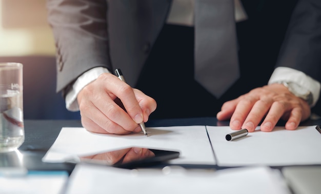 Close up business man signing contract making a deal, classic business.