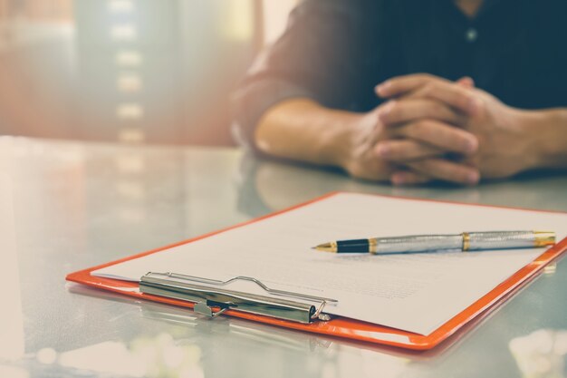 Close up of business man signing contract making a deal