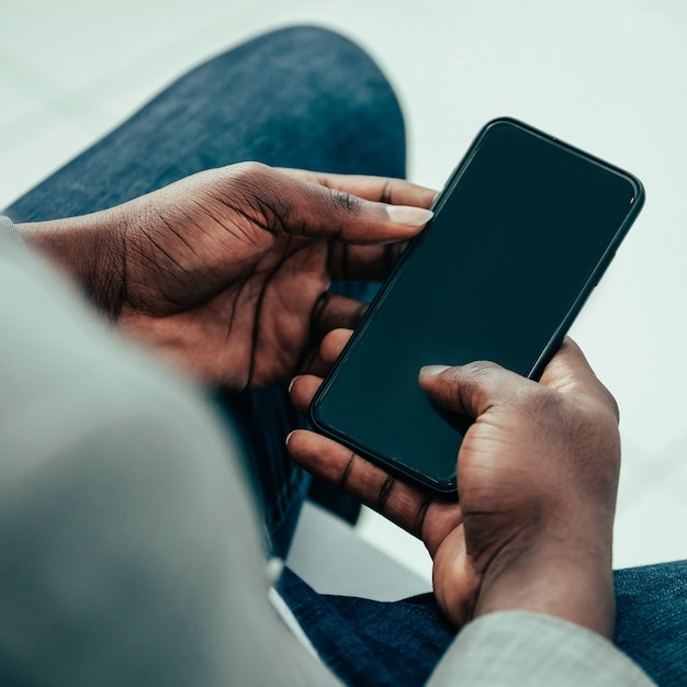 close up. business man using his smartphone . people and technology