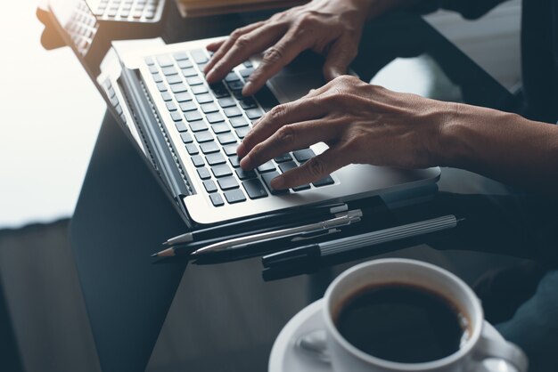 close up of business man working on laptop computer