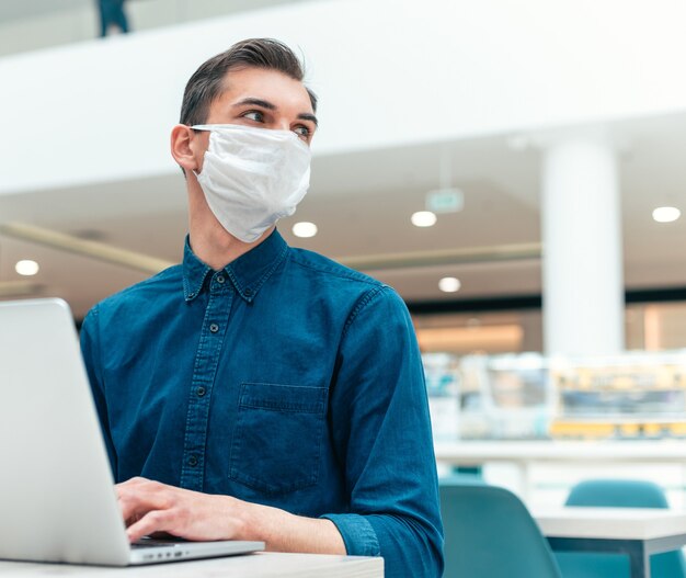 Close up. business man working on a laptop in an empty office. concept of health protection