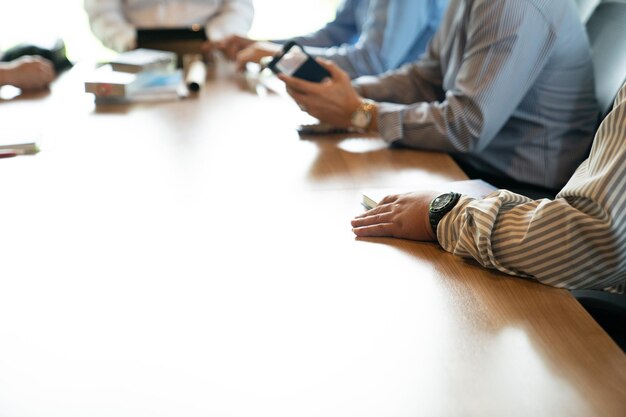 Close up business men's hand they are talking together on the wooden table at the afternoon