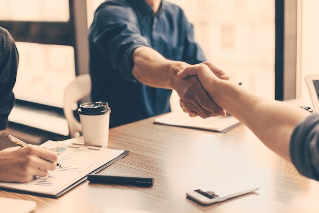 Close up business partners confirming the transaction with a handshake