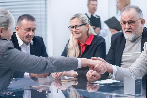 Close up business partners greet each other with a handshake