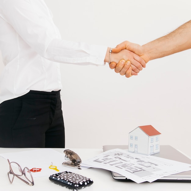 Close-up of business partners shaking hands after deal