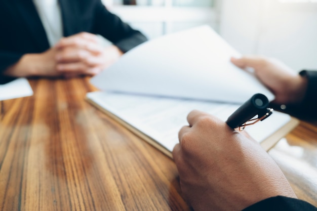 Close up of business partners sign contract at meeting Business people negotiating a contract