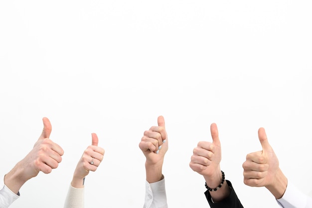 Photo close-up of business people hand's showing thumb up sign isolated over white background