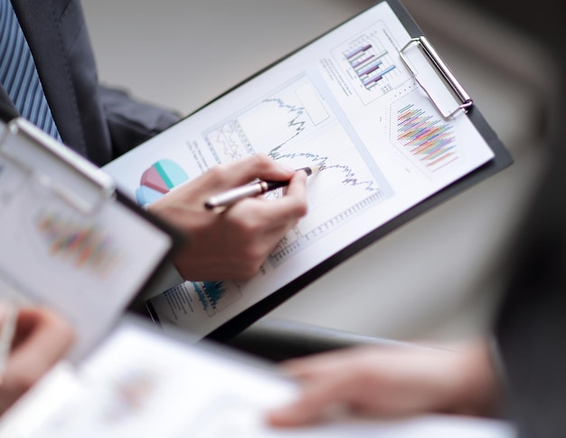 Close up of business people hands pointing growing financial bu