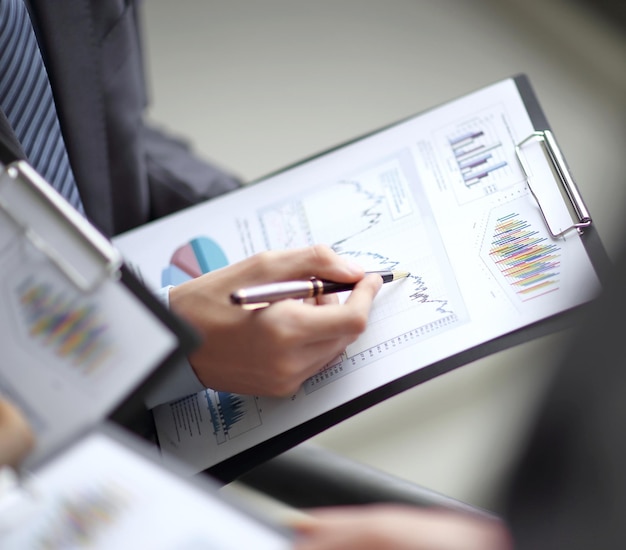 Close up of business people hands pointing growing financial business graph