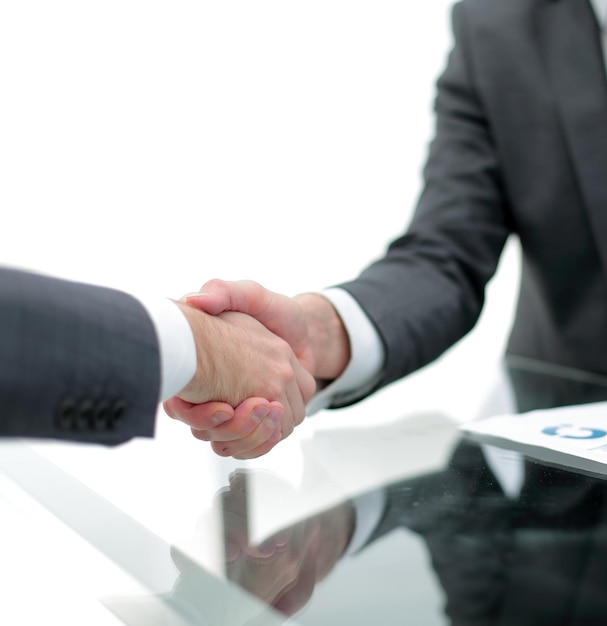 Close up business people handshake over the Desk