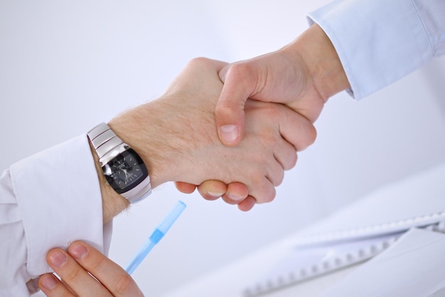 Close up of business people handshaking. Success communication concept