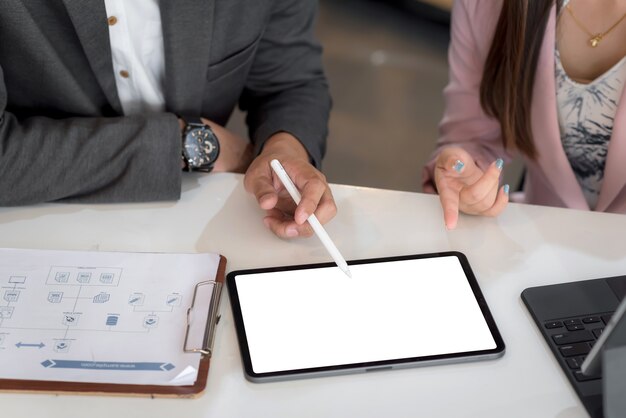 Close up business people holding a tablet blank white screen in the meeting room.