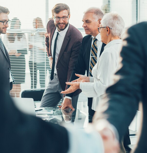 Close up business people shaking hands standing in the office