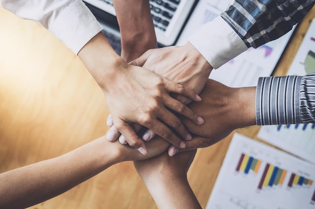 Close-up of business people stacking hands
