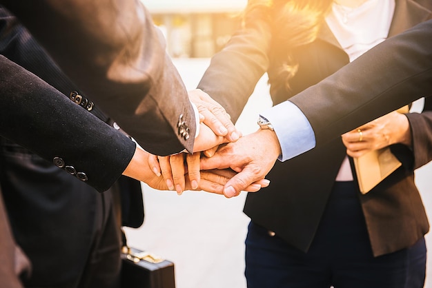 Close-up of business people stacking hands