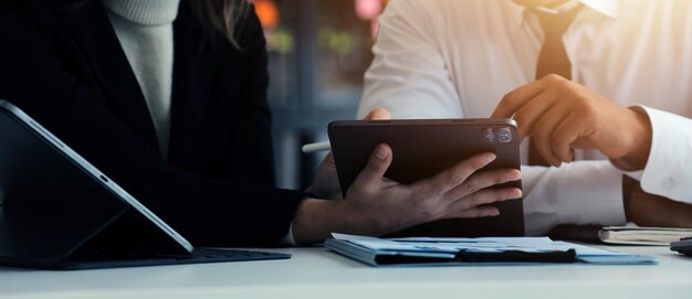 Photo close up of business team analyzing income charts and graphs with modern laptop computer business analysis and strategy concept