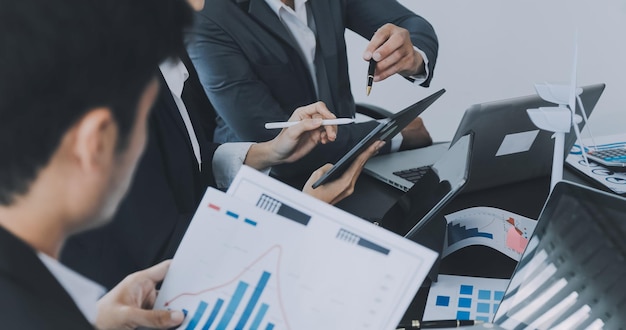 Close up of Business team analyzing income charts and graphs with modern laptop computer Business analysis and strategy concept