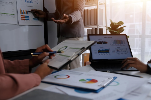 Close up of Business team analyzing income charts and graphs with modern laptop computer Business analysis and strategy concept