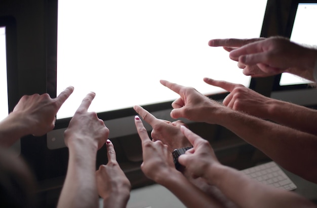 Close up business team pointing at computer monitor