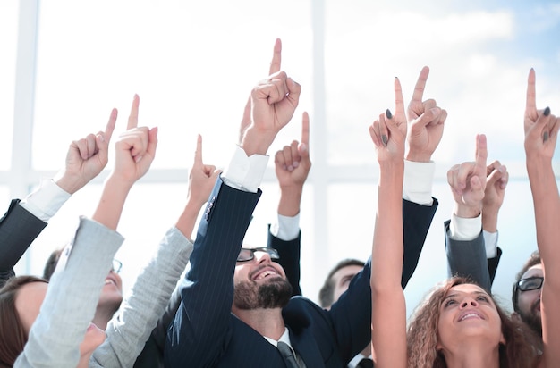 Close up business team pointing up to the copy space