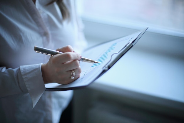 Close up business woman checking financial schedule