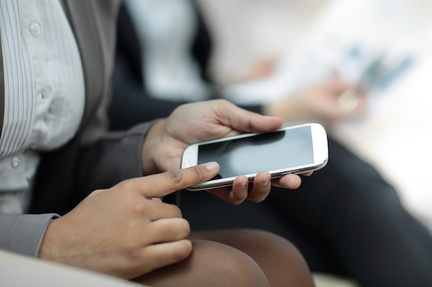 Close up.business woman presses the screen of the smartphone.