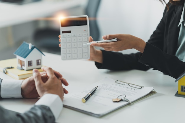 Close up Business woman or Real Estate agent explain signing agreement for buying house Bank manager and real estate concept