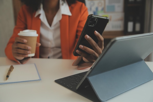 Close up Business woman using calculator and laptop for do math finance on wooden desk tax accounting statistics and analytical research concept