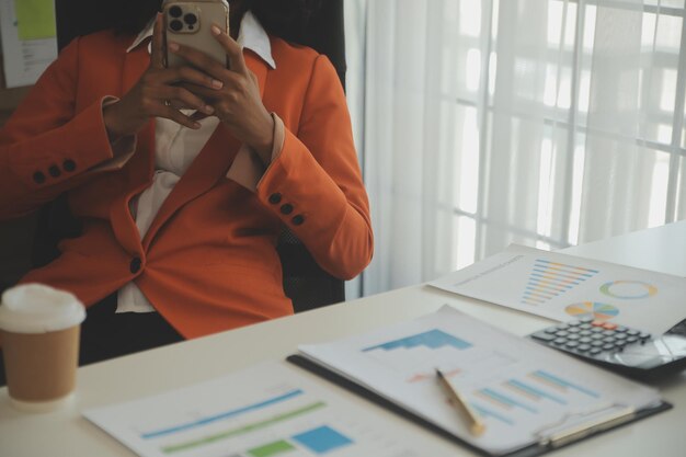 Close up Business woman using calculator and laptop for do math finance on wooden desk tax accounting statistics and analytical research concept