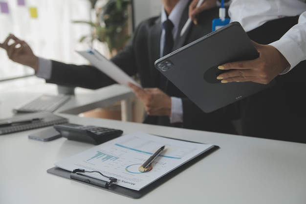 Close up Business woman using calculator and laptop for do math finance on wooden desk tax accounting statistics and analytical research concept