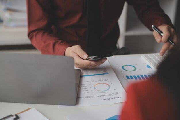 Close up Business woman using calculator and laptop for do math finance on wooden desk tax accounting statistics and analytical research concept