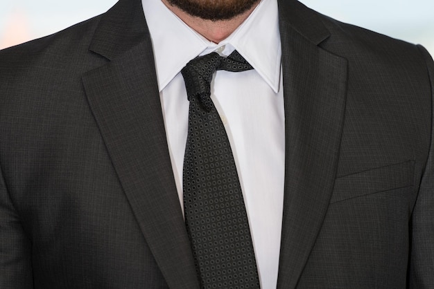 Close Up Of Businessman Adjusting Tie