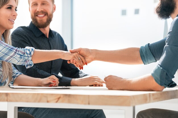 Close up businessman and businesswoman shaking hands