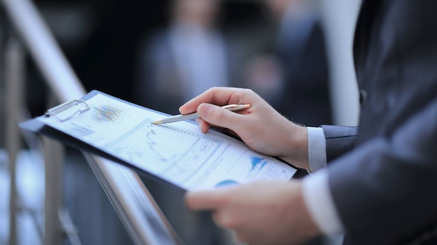 Close up businessman checking financial report in his office